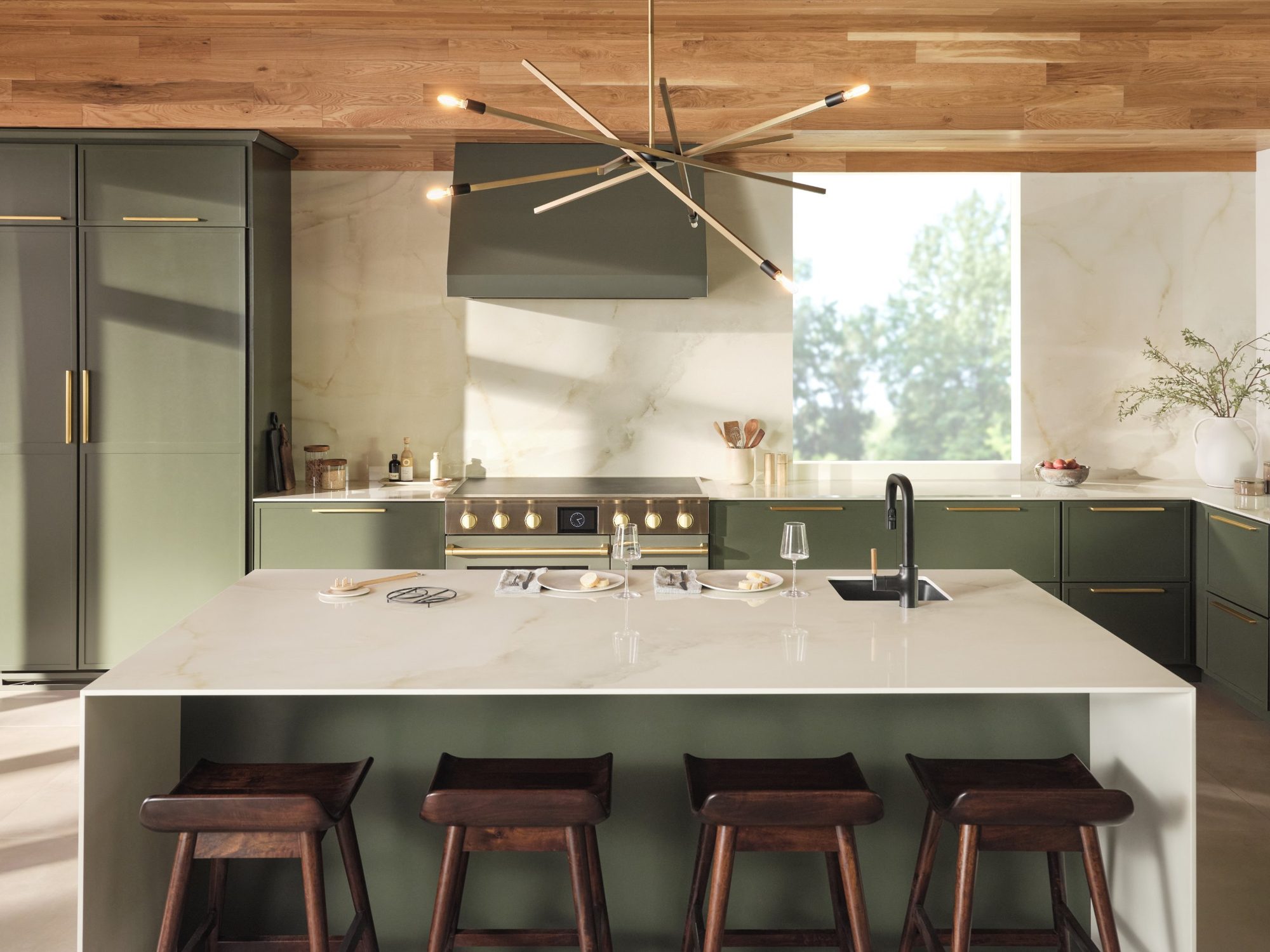 Olive cabinetry with a white stone waterfall island